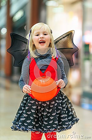 Happy girl with Halloween pumpkin Jack Oâ€™Lantern basket Stock Photo